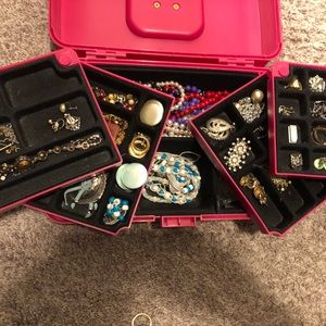 Pink jewelry box full of clip on earrings.